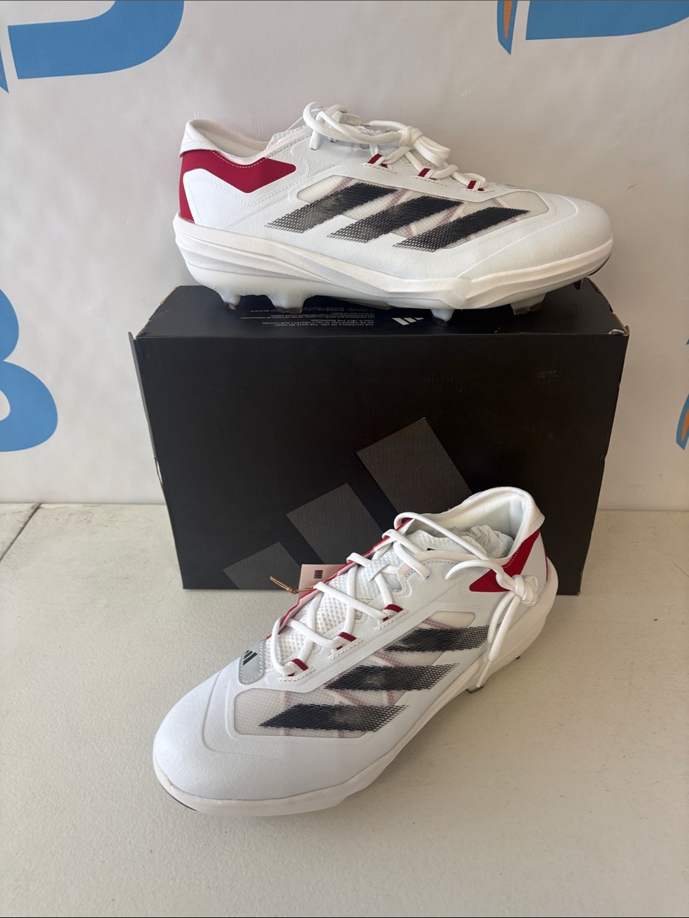 adidas White Cleats with Black Stripes and Red Accents